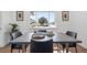 Elegant dining area featuring a modern table, stylish chairs, and ample natural light from a window at 3492 Edison Ave, Las Vegas, NV 89121