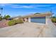 Long driveway leading up to home with landscaping and attached garage at 3492 Edison Ave, Las Vegas, NV 89121