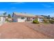 Landscaped front yard with gray exterior, and concrete driveway with gated fence at 3492 Edison Ave, Las Vegas, NV 89121