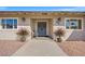 Inviting front entrance with neutral exterior, double doors, plants and wreaths at 3492 Edison Ave, Las Vegas, NV 89121
