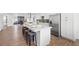 Spacious kitchen features a long island with bar stools, white cabinets, and stainless steel appliances at 3492 Edison Ave, Las Vegas, NV 89121