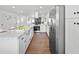 Bright, updated kitchen boasts white cabinets, an expansive island with seating, and modern stainless steel appliances at 3492 Edison Ave, Las Vegas, NV 89121