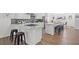 Bright kitchen boasts marble countertops, stainless steel appliances, and a large island with bar seating at 3492 Edison Ave, Las Vegas, NV 89121