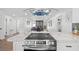 Spacious kitchen featuring a marble countertop island, stainless steel appliances, and modern lighting at 3492 Edison Ave, Las Vegas, NV 89121