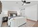 Inviting main bedroom featuring hardwood floors, modern decor, and a barn door at 3492 Edison Ave, Las Vegas, NV 89121