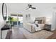 Bright main bedroom with hardwood floors, modern decor, and a sliding glass door to the patio at 3492 Edison Ave, Las Vegas, NV 89121