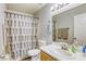 This bathroom has a large mirror and a shower-tub combo at 3882 Cinnamonwood Way, Las Vegas, NV 89115