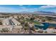 Picturesque aerial view of a neighborhood featuring a golf course, lake and mountain views at 4820 Grey Wolf Ln # 101, Las Vegas, NV 89149