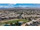 This aerial showcases homes nestled within a lush golf course setting against a mountain backdrop at 4820 Grey Wolf Ln # 101, Las Vegas, NV 89149