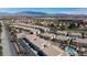 Aerial view of a large townhome community, lush desert landscaping, golf course, mountains in the distance at 4820 Grey Wolf Ln # 101, Las Vegas, NV 89149
