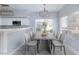 Bright and airy dining area with modern decor, wooden table, large window, and wooden chandelier at 4820 Grey Wolf Ln # 101, Las Vegas, NV 89149