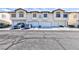 Exterior townhome view showcasing attached garages, and well-maintained landscaping at 4820 Grey Wolf Ln # 101, Las Vegas, NV 89149