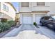 Close up exterior view featuring attached garages, driveways, and desert landscaping at 4820 Grey Wolf Ln # 101, Las Vegas, NV 89149