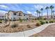 Exterior residential view with sidewalk featuring mature palm trees and desert landscaping at 4820 Grey Wolf Ln # 101, Las Vegas, NV 89149