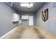 Spacious garage with built-in storage cabinets and a Golden Knights logo on the wall at 4820 Grey Wolf Ln # 101, Las Vegas, NV 89149