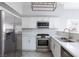 Bright kitchen features stainless steel appliances, white cabinets, and modern backsplash at 4820 Grey Wolf Ln # 101, Las Vegas, NV 89149