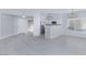 Bright kitchen with white cabinetry, stainless steel appliances, eat-in counter, and modern fixtures at 4820 Grey Wolf Ln # 101, Las Vegas, NV 89149