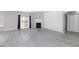 Open concept living room featuring light gray vinyl flooring, fireplace and sliding glass door at 4820 Grey Wolf Ln # 101, Las Vegas, NV 89149