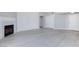 Open-plan living area featuring light gray flooring and a charming white fireplace and a light gray wall at 4820 Grey Wolf Ln # 101, Las Vegas, NV 89149