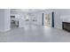 Spacious and modern living area with light gray flooring, fireplace, and open access to the kitchen at 4820 Grey Wolf Ln # 101, Las Vegas, NV 89149