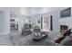 Modern living area featuring a cozy fireplace, light gray vinyl flooring, and kitchen with stainless steel appliances at 4820 Grey Wolf Ln # 101, Las Vegas, NV 89149