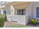 Private patio with stucco wall and lush green bushes for added privacy at 4820 Grey Wolf Ln # 101, Las Vegas, NV 89149