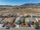 Aerial view showcasing the property within a neighborhood setting, with mountain views in the distance at 5050 Nw Valdez Ct, Pahrump, NV 89060