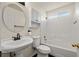Full bathroom featuring white cabinets, a pedestal sink, and a shower-over-tub combination at 5050 Nw Valdez Ct, Pahrump, NV 89060