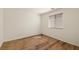 Bright bedroom with wood-look flooring, a window with blinds, and ample natural light at 5050 Nw Valdez Ct, Pahrump, NV 89060