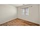 Clean bedroom with wood-look flooring, a window with blinds, and neutral tones at 5050 Nw Valdez Ct, Pahrump, NV 89060