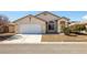 Single-story home with a two-car garage and low-maintenance desert landscaping at 5050 Nw Valdez Ct, Pahrump, NV 89060