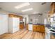 Spacious kitchen with wood cabinets, wood floors, stainless steel appliances, and a view to the backyard at 5050 Nw Valdez Ct, Pahrump, NV 89060