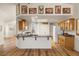 Kitchen with wood cabinets, light countertops, recessed lighting, stainless steel appliances, and wood flooring at 5050 Nw Valdez Ct, Pahrump, NV 89060