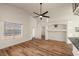Bright living room with vaulted ceilings, wood floors, decorative nooks, and a large window overlooking the backyard at 5050 Nw Valdez Ct, Pahrump, NV 89060