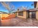 Backyard patio with a block wall, sliding glass door, and a covered patio at 5101 Village Dr, Las Vegas, NV 89142