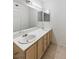 Bright bathroom featuring a vanity with a white countertop, wood cabinets, and double sinks at 5265 Caspian Springs Dr # 201, Las Vegas, NV 89120