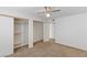 Bright bedroom with carpet flooring, a ceiling fan, and a closet with white sliding doors at 5265 Caspian Springs Dr # 201, Las Vegas, NV 89120