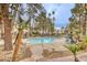 Relaxing community pool surrounded by lush greenery and comfortable seating arrangements at 5265 Caspian Springs Dr # 201, Las Vegas, NV 89120