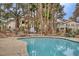 Community pool area offers serene relaxation amidst lush landscaping and convenient seating at 5265 Caspian Springs Dr # 201, Las Vegas, NV 89120