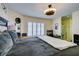 A primary bedroom with a ceiling fan, big window, and adjoining bathroom and desk at 5309 Silverheart Ave, Las Vegas, NV 89142