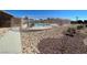Community pool surrounded by light metal fencing, desert landscaping, and a walkway to provide access at 5721 Heineken Dr, North Las Vegas, NV 89031