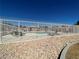 Exterior view of the community pool surrounded by fencing and desert landscaping at 5721 Heineken Dr, North Las Vegas, NV 89031