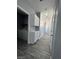 Hallway with overhead cabinets and laundry room view, maximizing storage and convenience at 5721 Heineken Dr, North Las Vegas, NV 89031