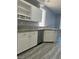 Well-lit kitchen featuring white cabinetry, stainless steel appliances, and speckled granite countertops at 5721 Heineken Dr, North Las Vegas, NV 89031