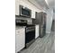 Modern kitchen with stainless steel appliances, white cabinets, and gray countertops at 5721 Heineken Dr, North Las Vegas, NV 89031
