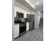 Kitchen featuring stainless steel appliances, gas range, and gray wood floors at 5721 Heineken Dr, North Las Vegas, NV 89031
