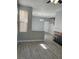 Spacious living room featuring gray wood floors, modern paint, and a stone fireplace at 5721 Heineken Dr, North Las Vegas, NV 89031