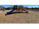 Brightly colored play structure with slides and climbing areas sits in the community playground at 5721 Heineken Dr, North Las Vegas, NV 89031