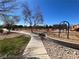 A well-maintained walking path leads through a community area with landscaping and park benches at 5721 Heineken Dr, North Las Vegas, NV 89031
