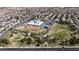 Aerial view featuring Lee Antonello Elementary School with playing fields and playground, showcasing surrounding neighborhood at 5850 Grey Wood Way, North Las Vegas, NV 89031